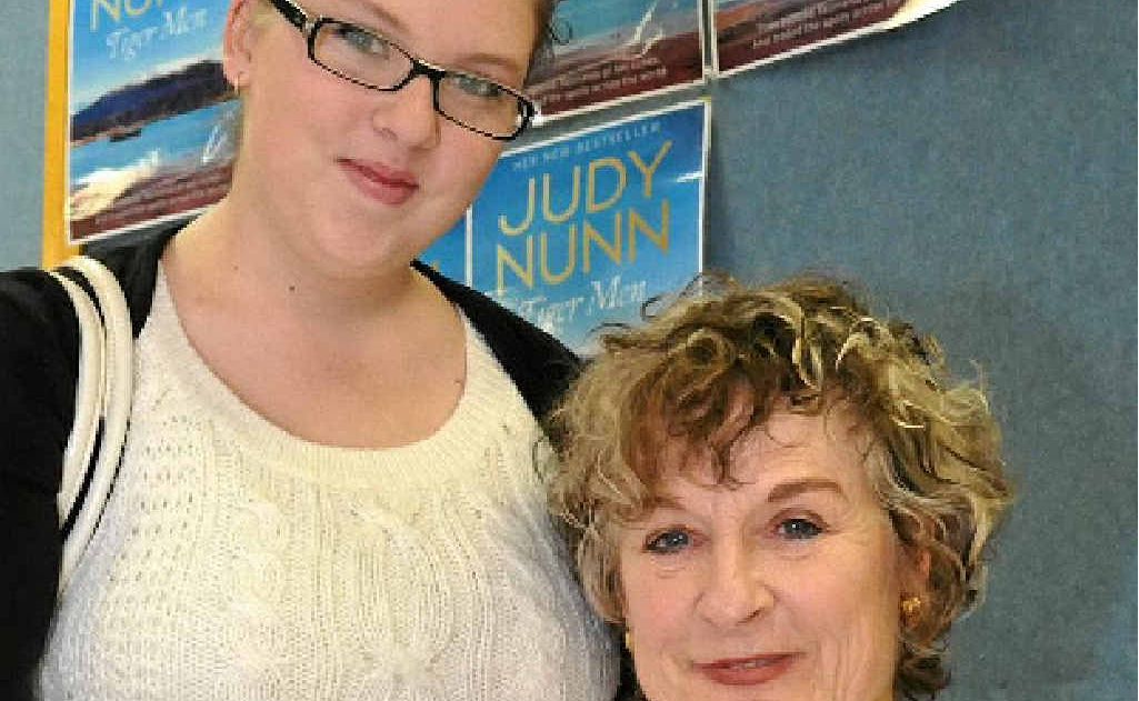 Author and actor Judy Nunn (right) signs a copy of her new book, Tiger Men, for fan Rebecca Dudley.